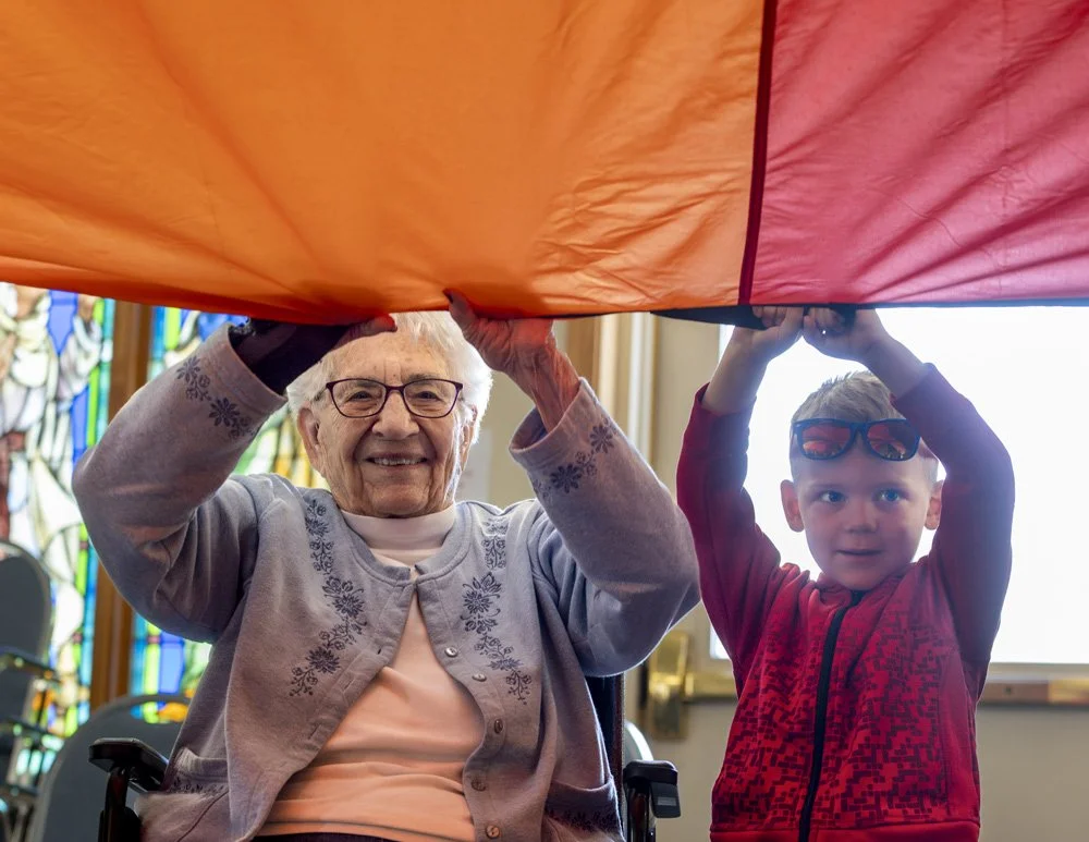 Residents enjoy recreational activities with children enrolled in Grandkids child care