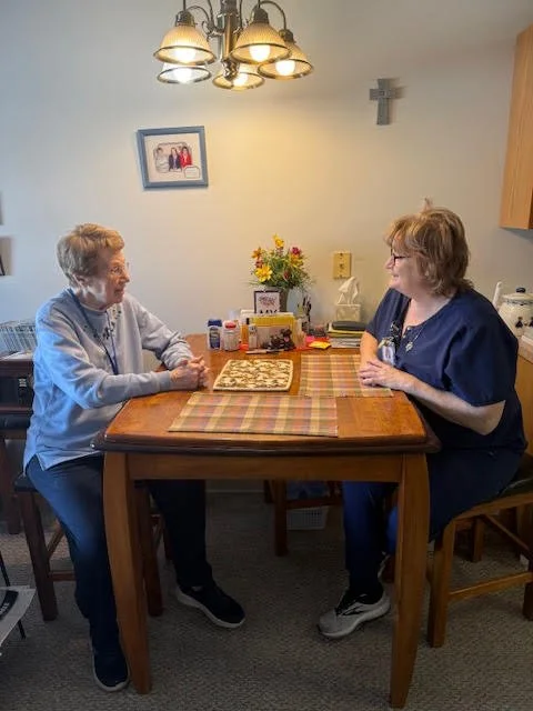 Cottonwood Ridge manager visiting with a resident of the senior housing facility at St. John's in Brown County, Minnesota