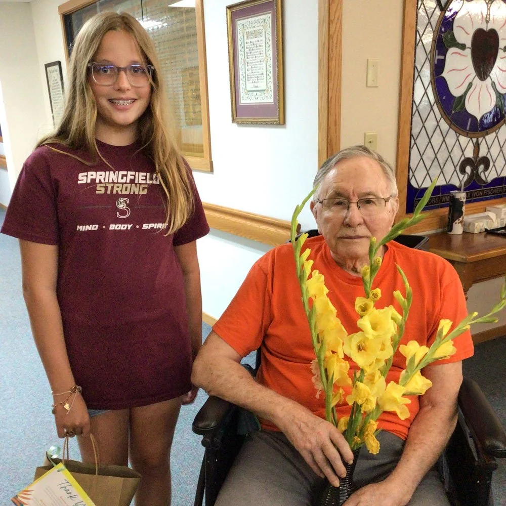Youth volunteer with a resident of St. John's Circle of Care, Brown County MN