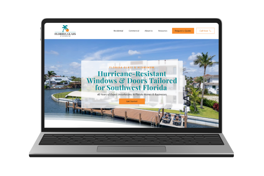 Laptop displaying a website for Florida Glass & Aluminum, featuring a waterfront background with palm trees and houses, and text highlighting hurricane-resistant windows and doors tailored for Southwest Florida.