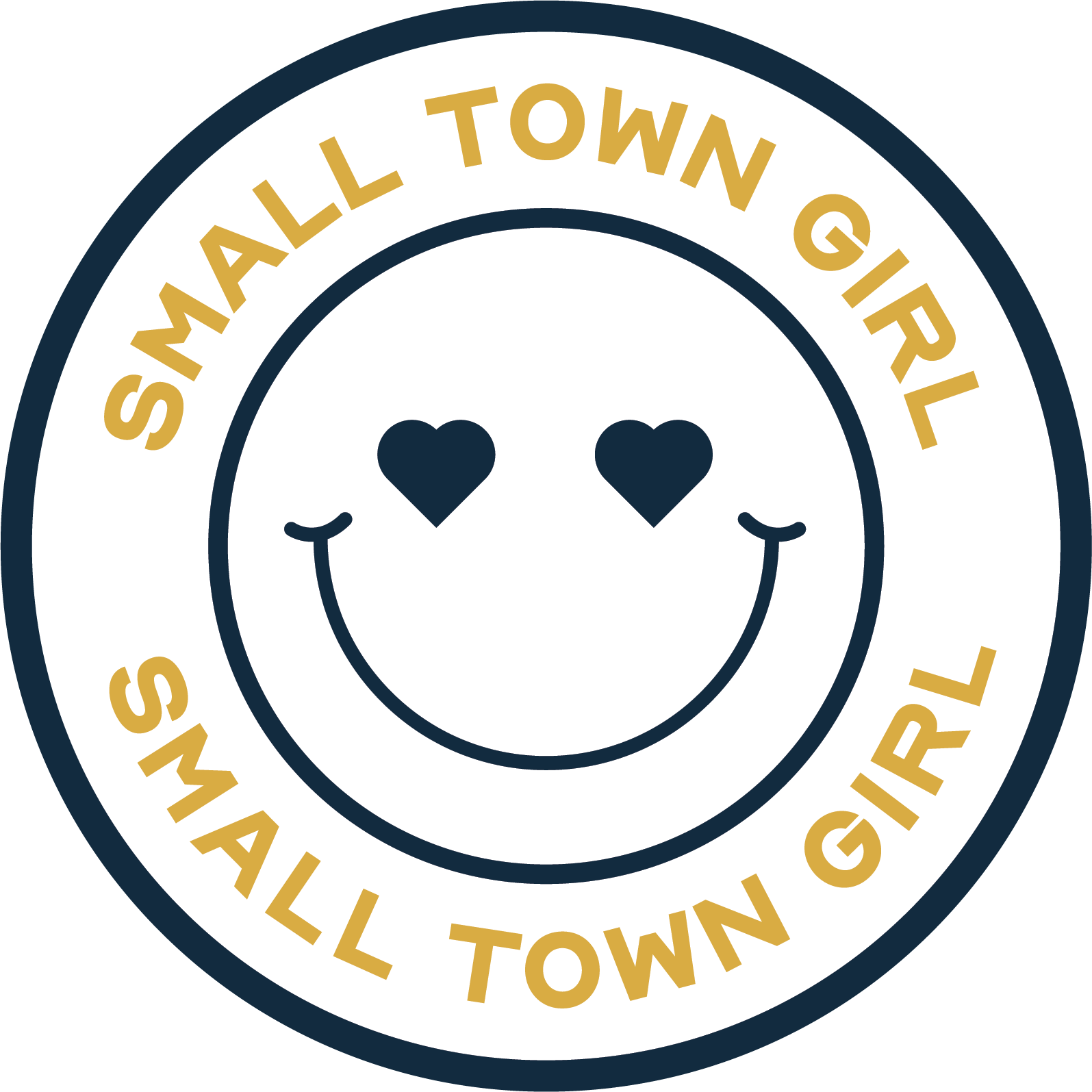A circular logo with the words "Small Town Girl" repeated at the top and bottom in gold text. In the center, there is a white smiley face with heart-shaped eyes.