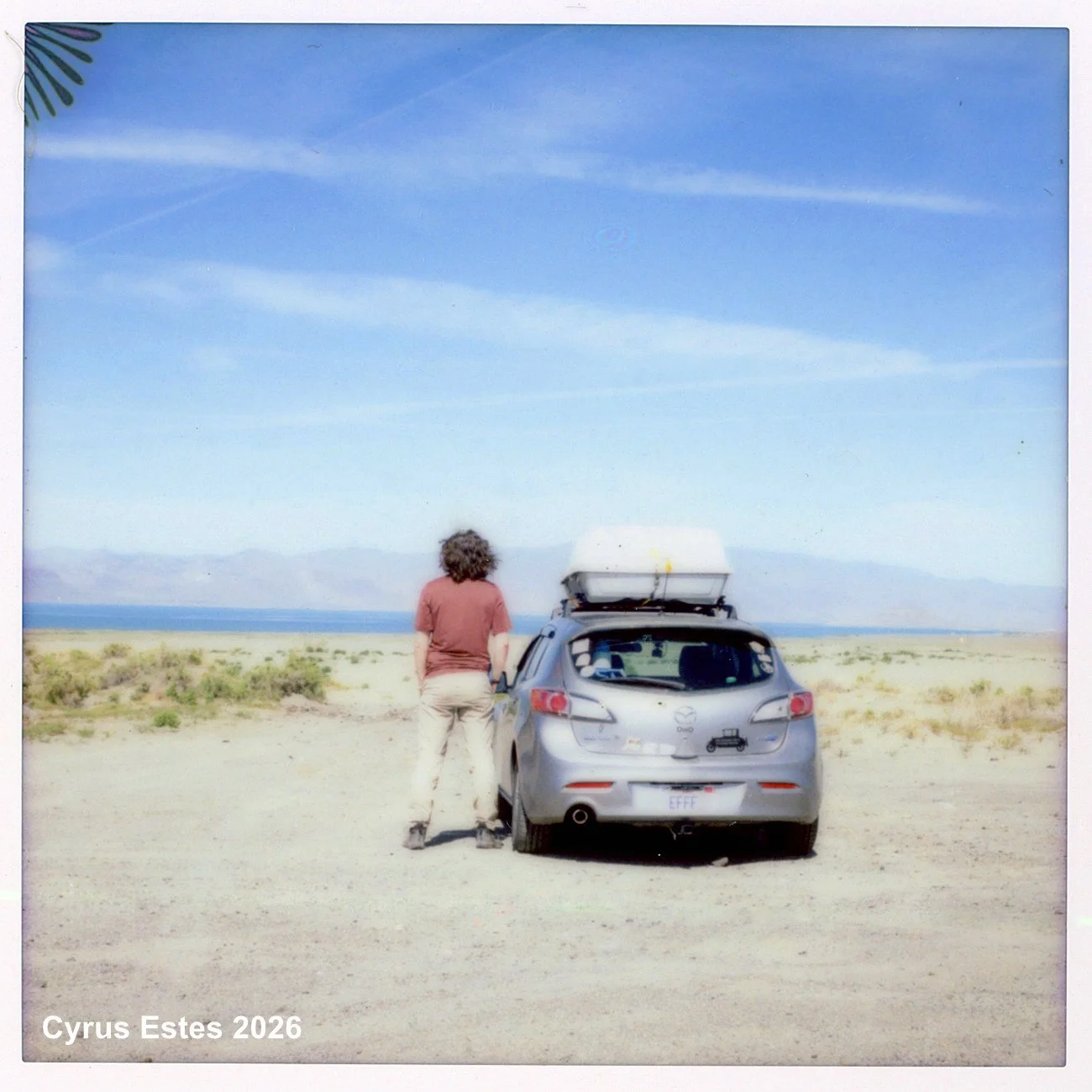 Self portrait, looking out over Pyramid Lake, Nevada. Lomo' Instant Square. Fuji Instax Square instant film.