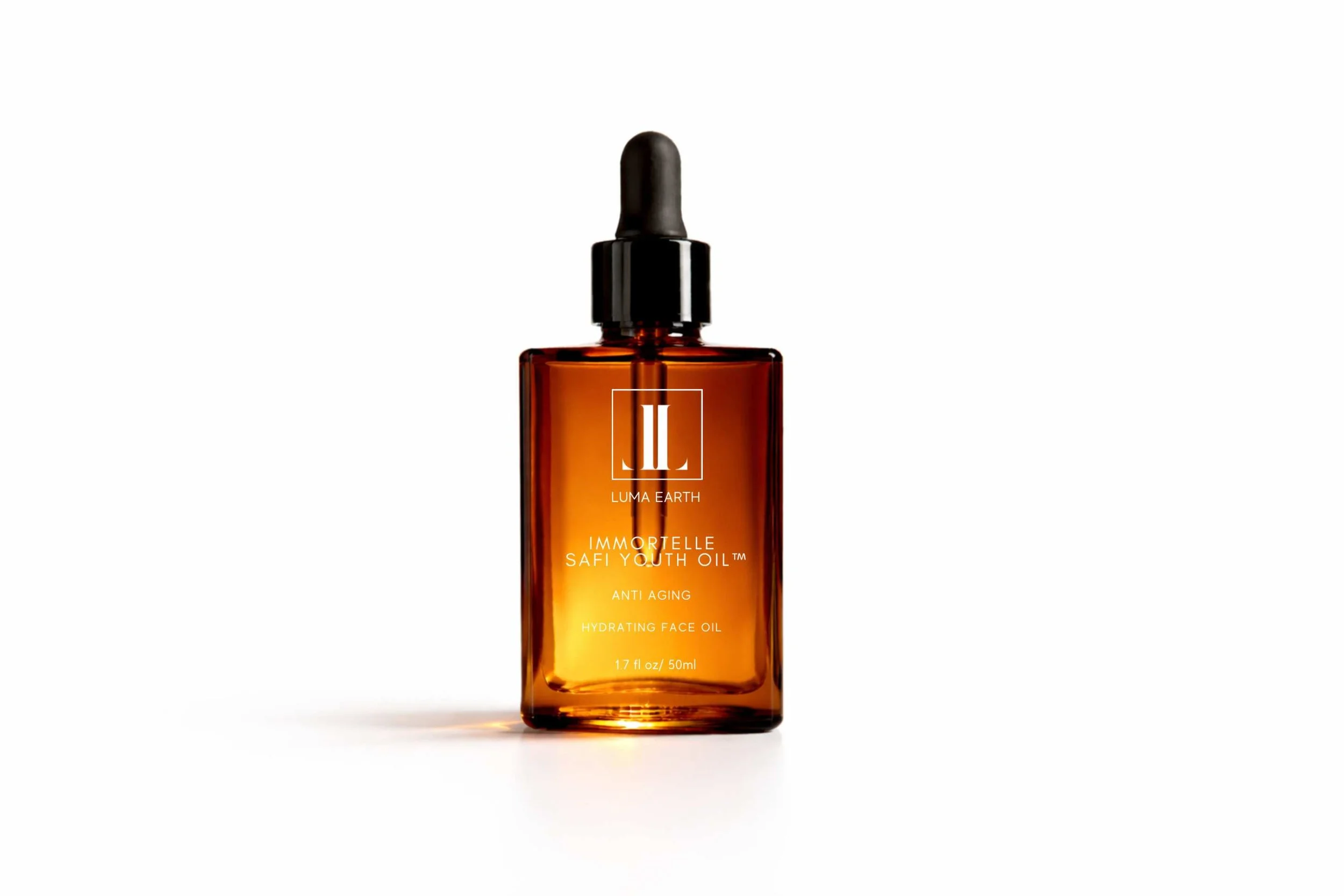 Amber glass bottle of Luma Earth Immortelle Safi Youth Oil with black dropper cap, placed on a white background.