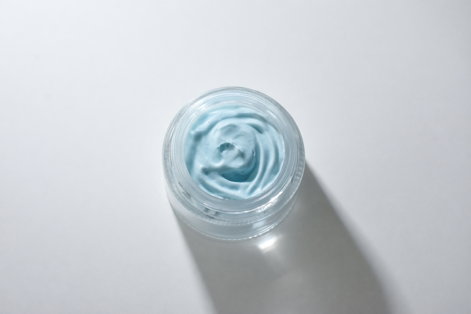 Light blue cream in glass jar.png