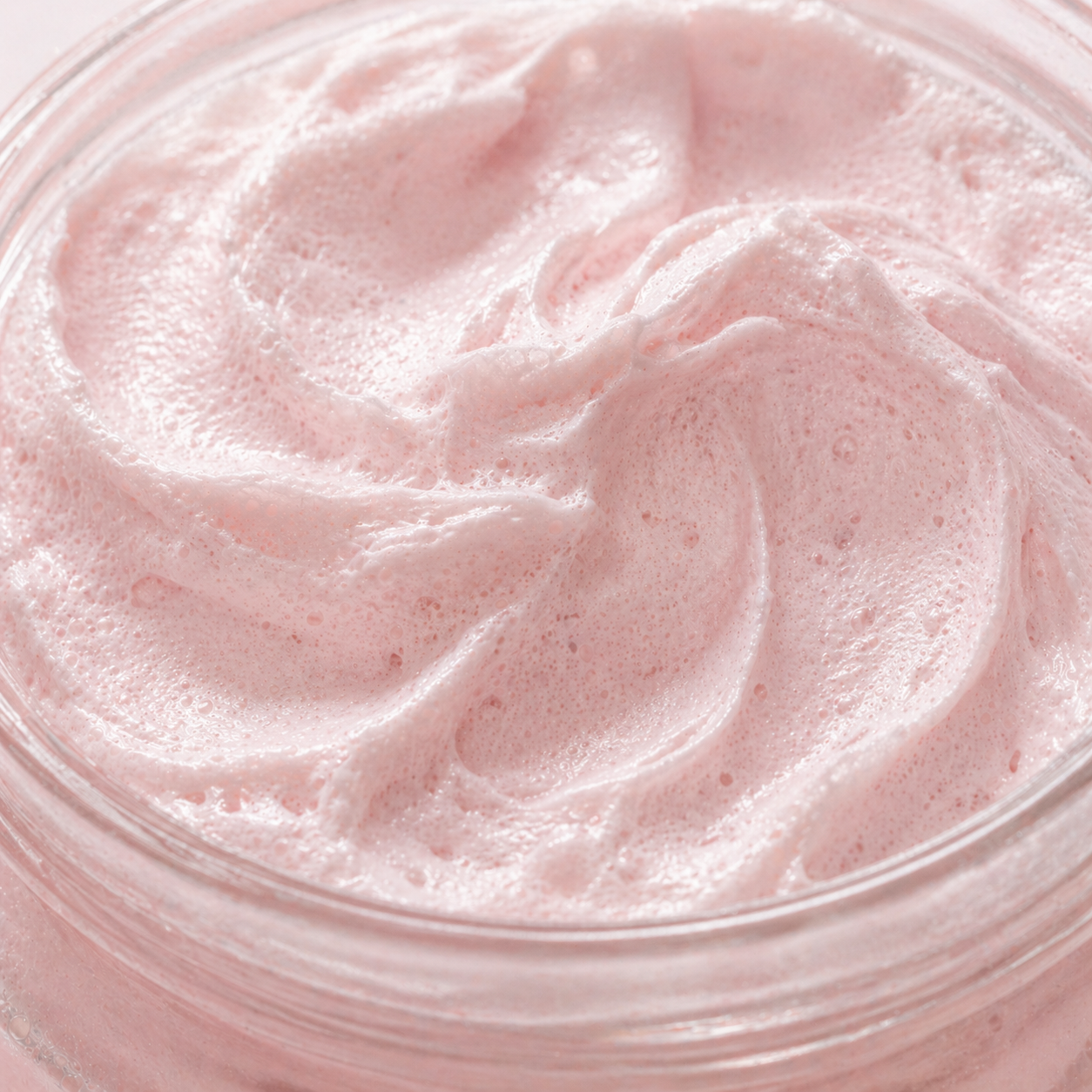 Close-up of pink whipped mousse in a jar.