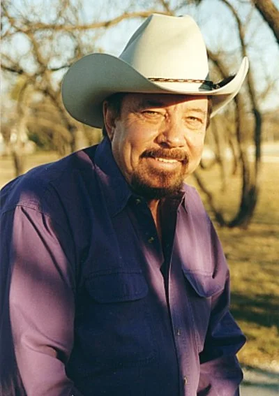 Curtis Potter smiling and wearing a cowboy hat
