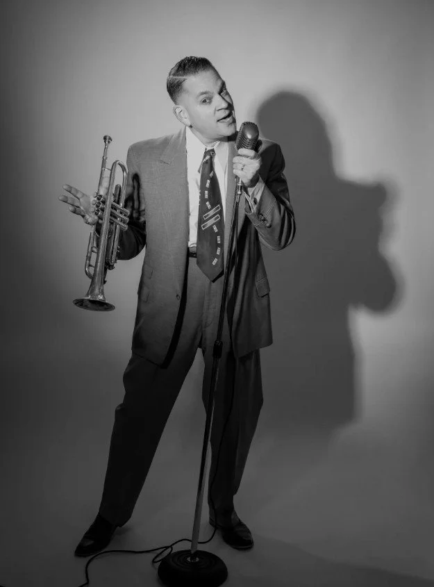 Rob Dehlinger with instrument and posing to sing