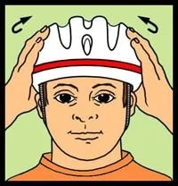 Child adjusting a white protective helmet with red stripe.