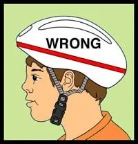 A person wearing a white bicycle helmet with the word 'WRONG' written on it, indicating incorrect helmet positioning.