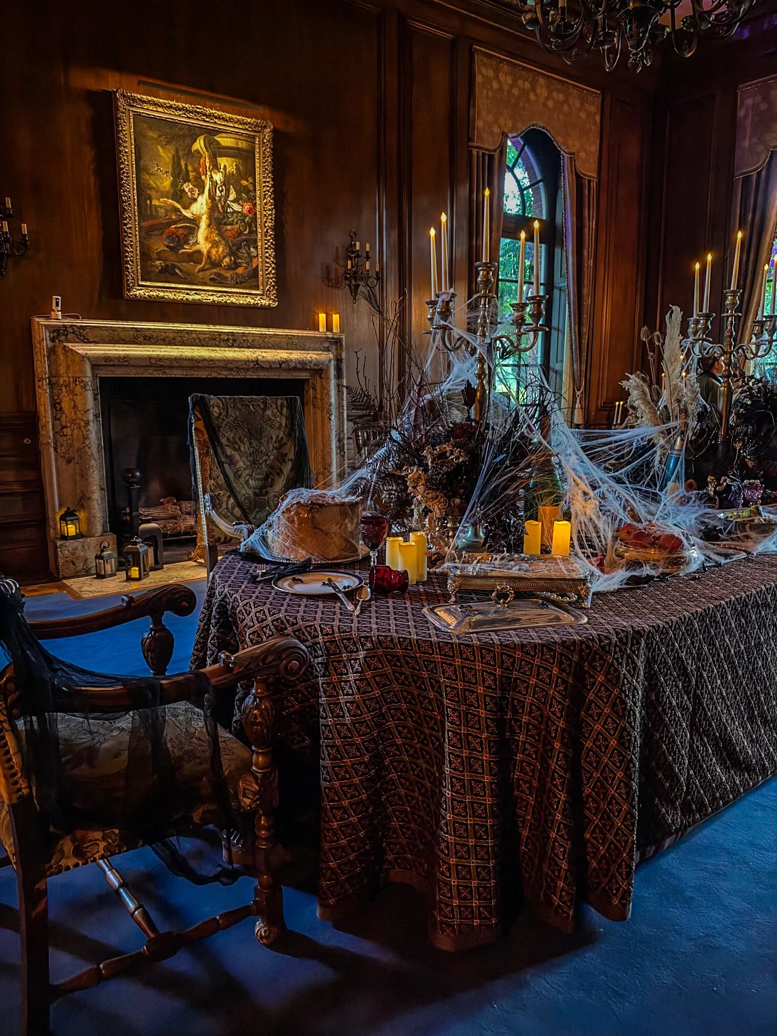 Filoli’s Historic House decorated for Nightfall with candlelit candelabras, cobwebs and dramatic gothic Halloween décor in the dining room.