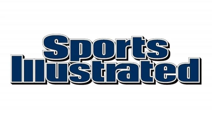Sports Illustrated logo in bold, blue 3D text on a white background.