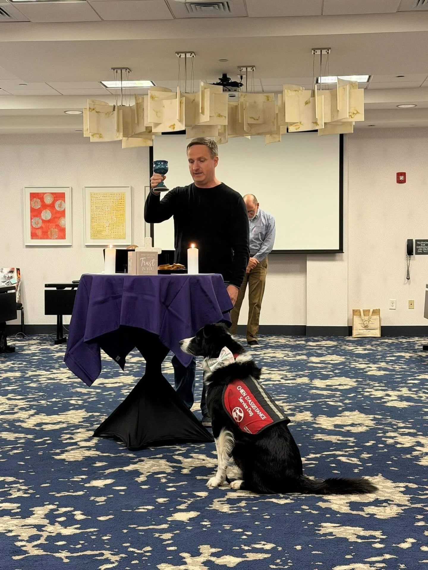 Photo by Sandy Morgan Messick. Rilla is an experienced altar assistant, even at improvised hotel meeting room altars.