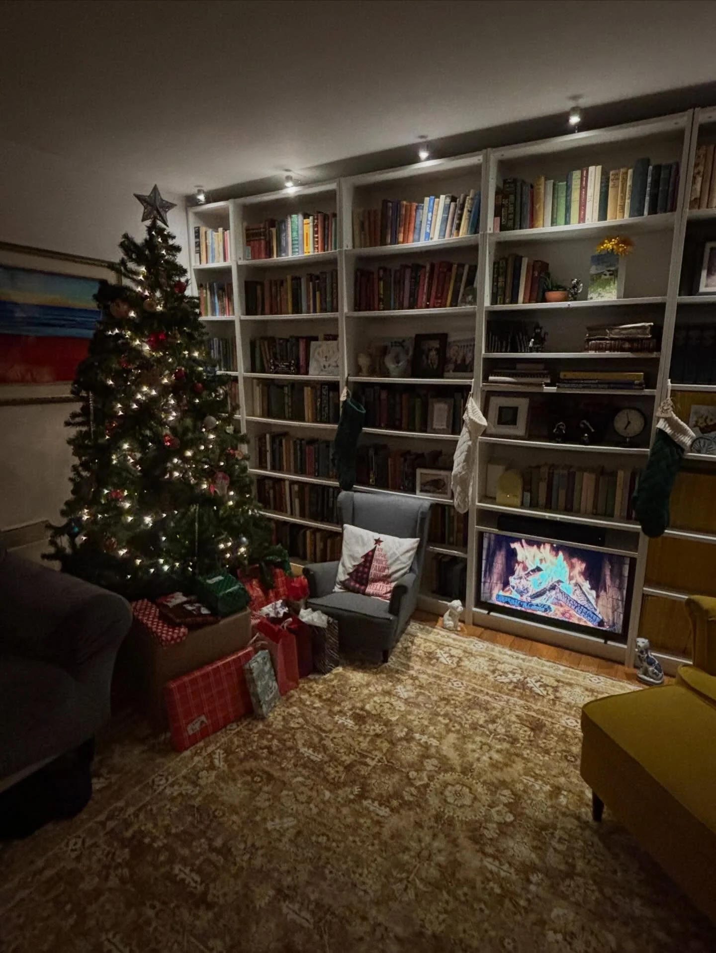 Fake tree, fake fire, real family.

In old-fashioned Qu&eacute;b&eacute;cois tradition, we celebrate by going to a Christmas Eve service, eating a b&ucirc;che de No&euml;l (a cake designed to look, but not taste like, a fireplace log), and opening pr