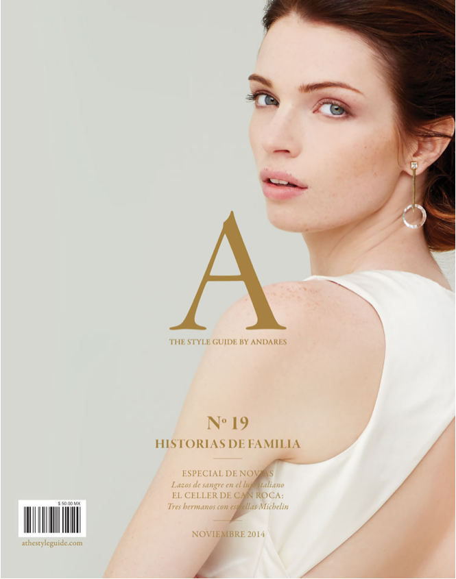 Cover of a magazine featuring a woman with fair skin, red hair, and blue eyes looking over her shoulder, wearing a white sleeveless top and a drop earring, with text about family history and fashion.