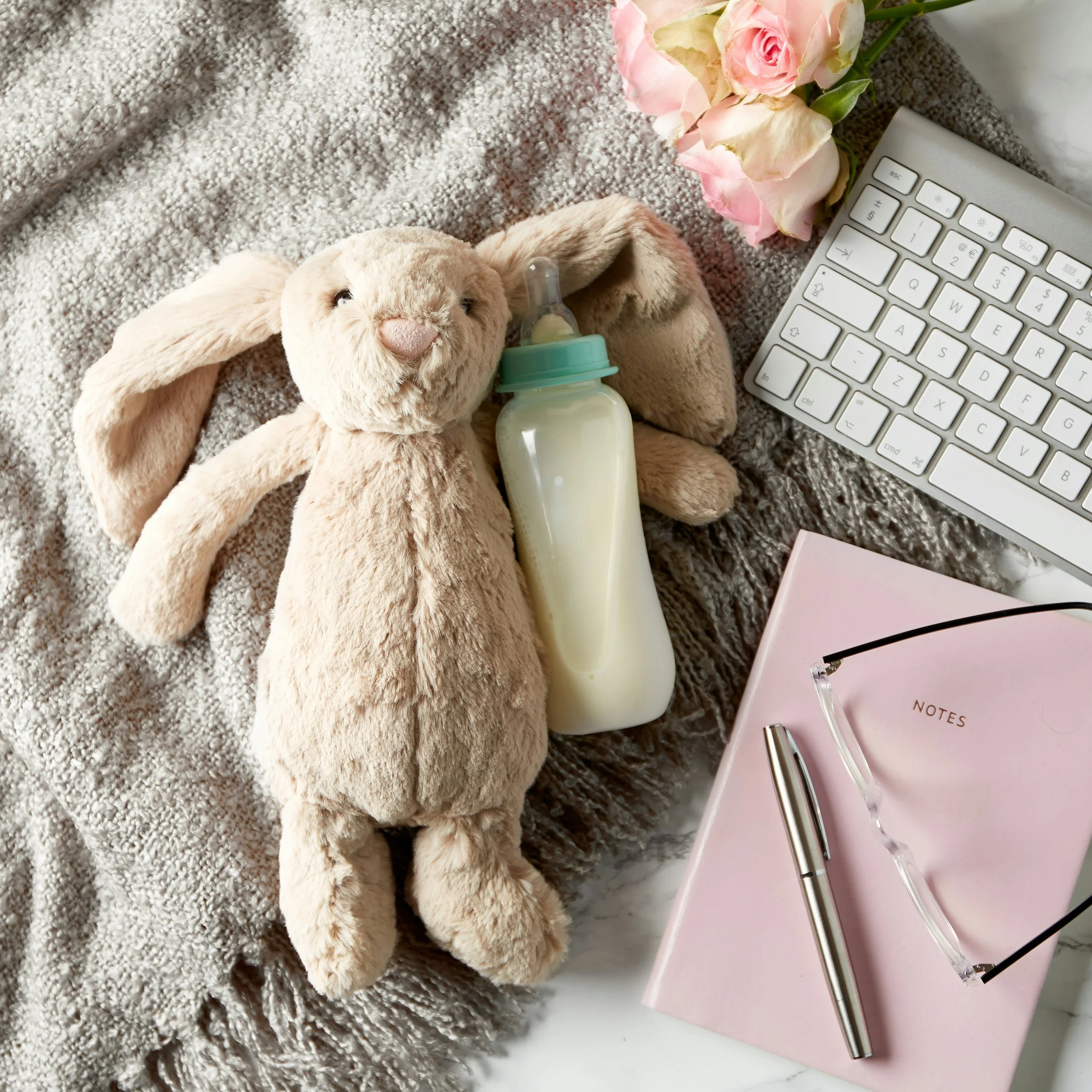 Bunny, bottle, and journal on a blanket
