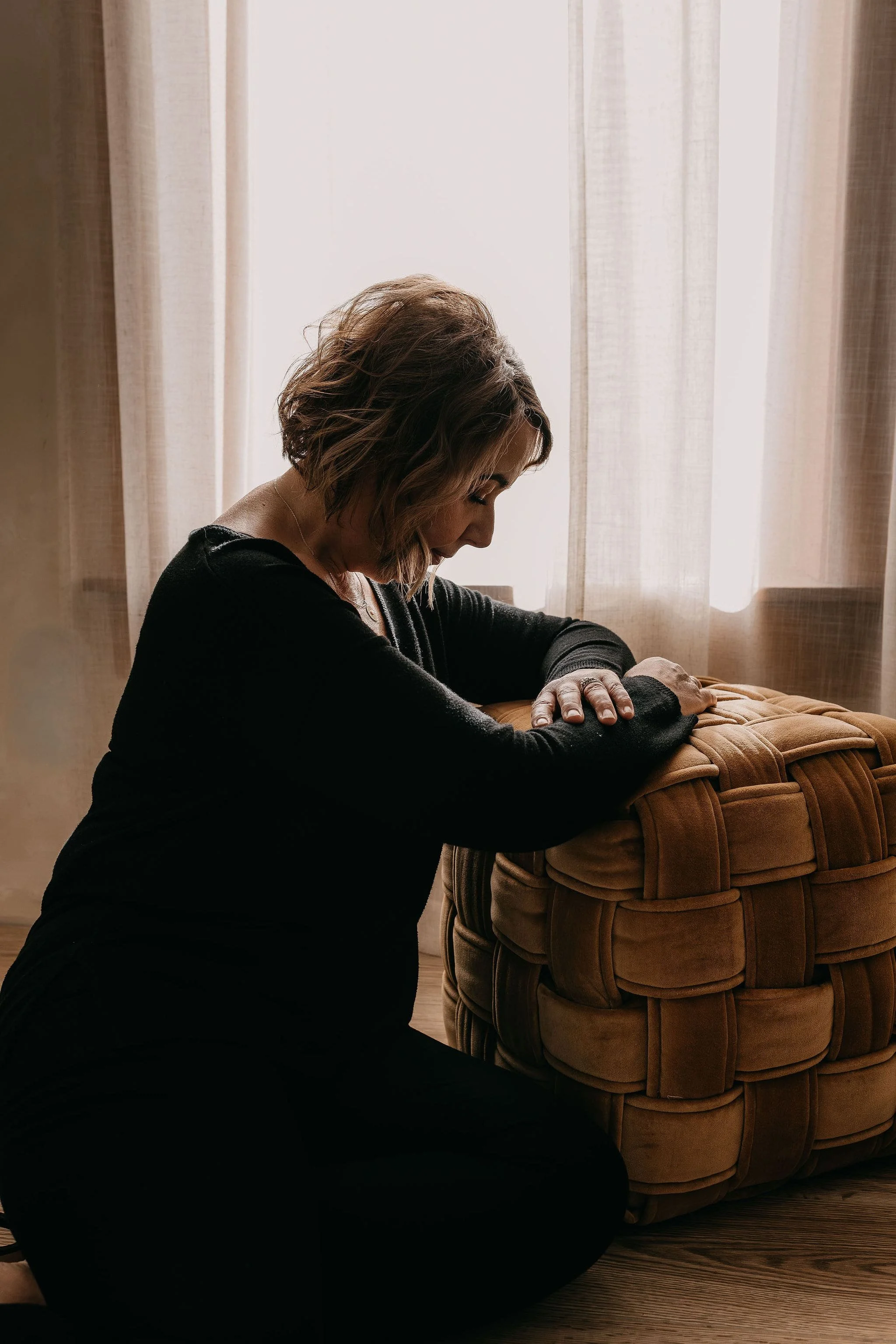 Melisa kneeling by divan