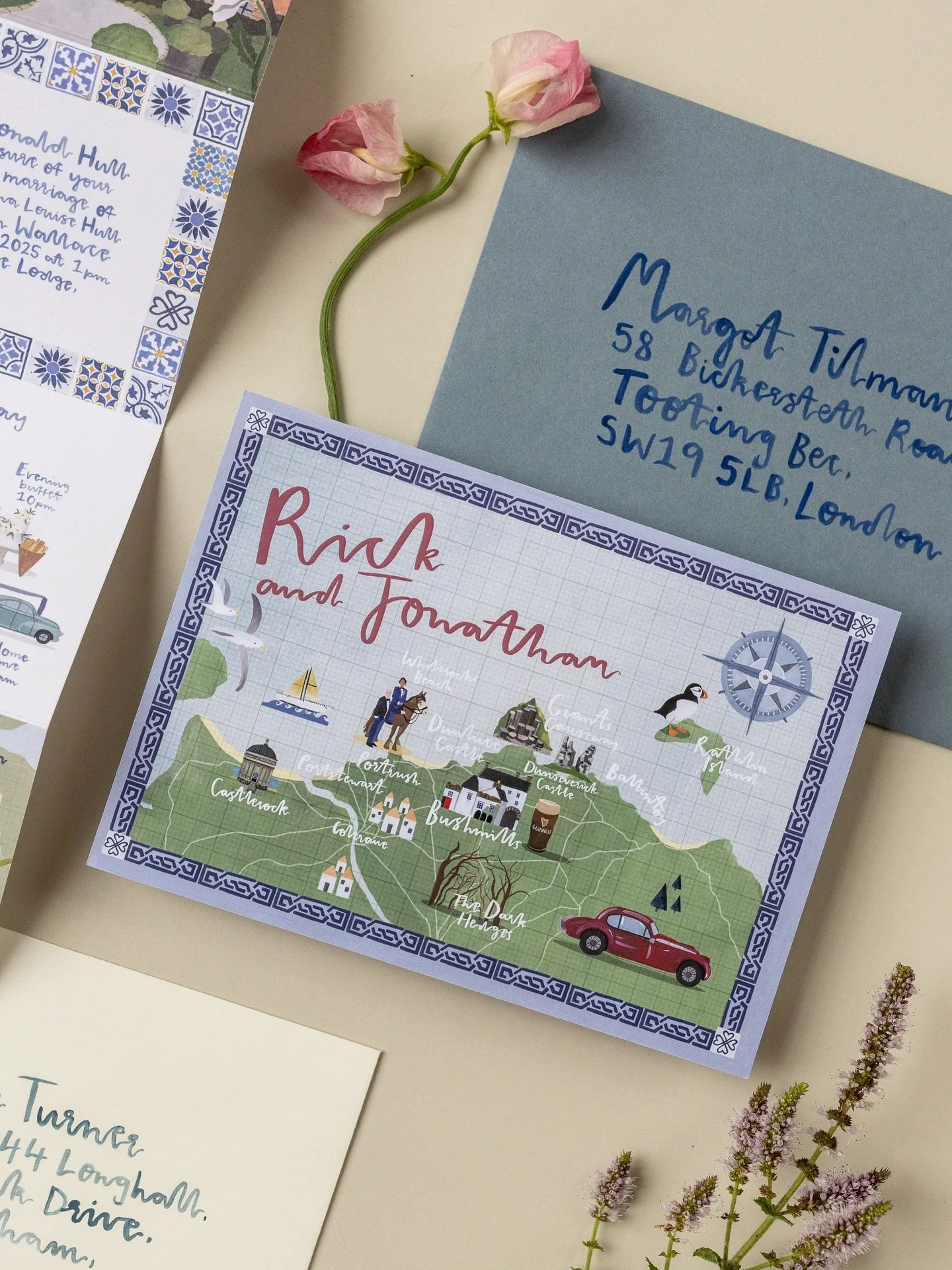 Some snaps of a postcard style wedding announcement, with wording on the back for Rick and Jonathan's elopement on the epic North Coast of Northern Ireland 🌊

The map shows all of the places they went to with little illustrations for each location ?