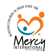 Mercy International logo featuring stylized orange and blue figures forming a heart shape with the slogan 'Rescuing Children in Crisis Since 1985'.