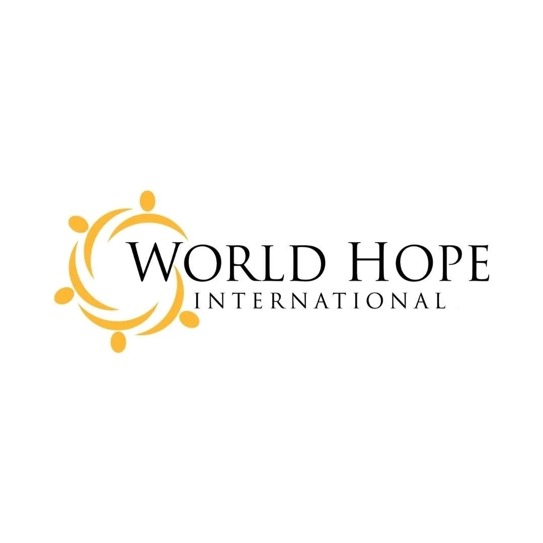 Logo of World Hope International with a yellow circular symbol and black text on a white background.