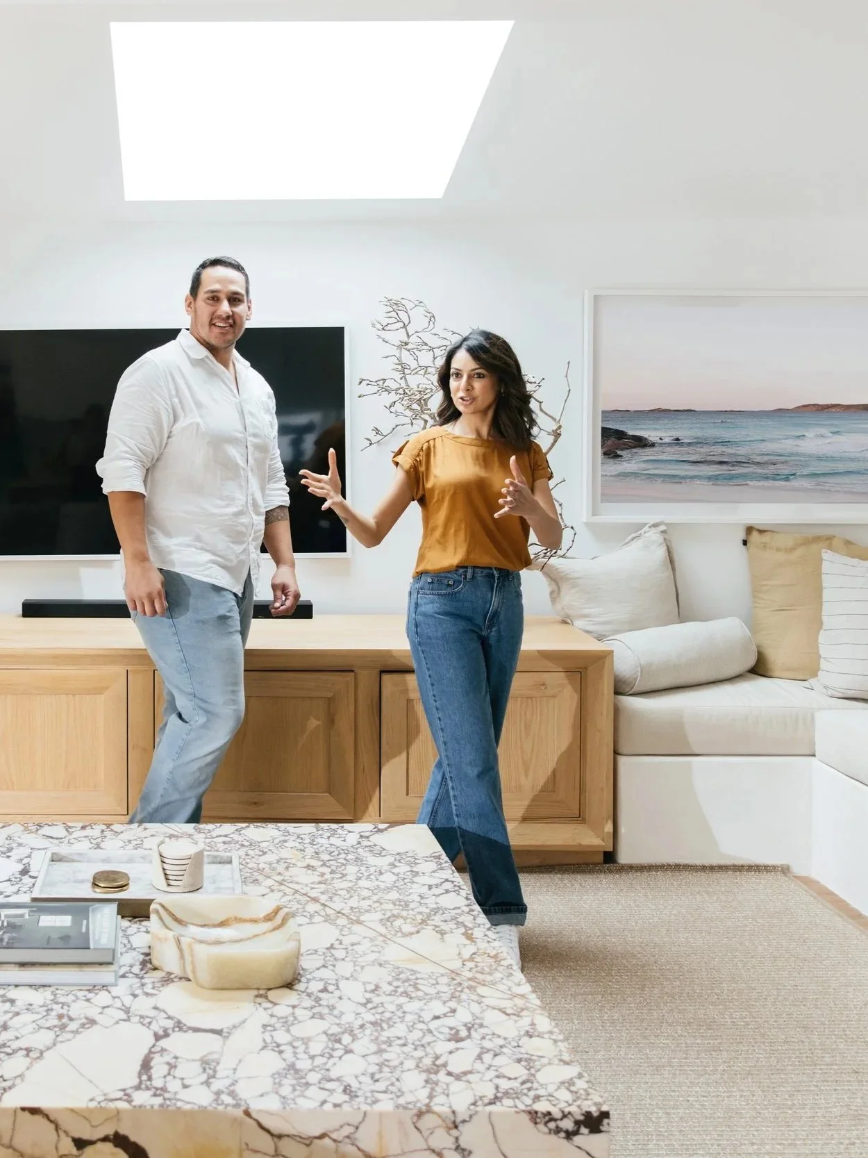 Prospective buyers exploring a modern living room during a private property viewing, illustrative of premium home. Sell your Bream Bay property with James Alexander and Charlotte Daun.
