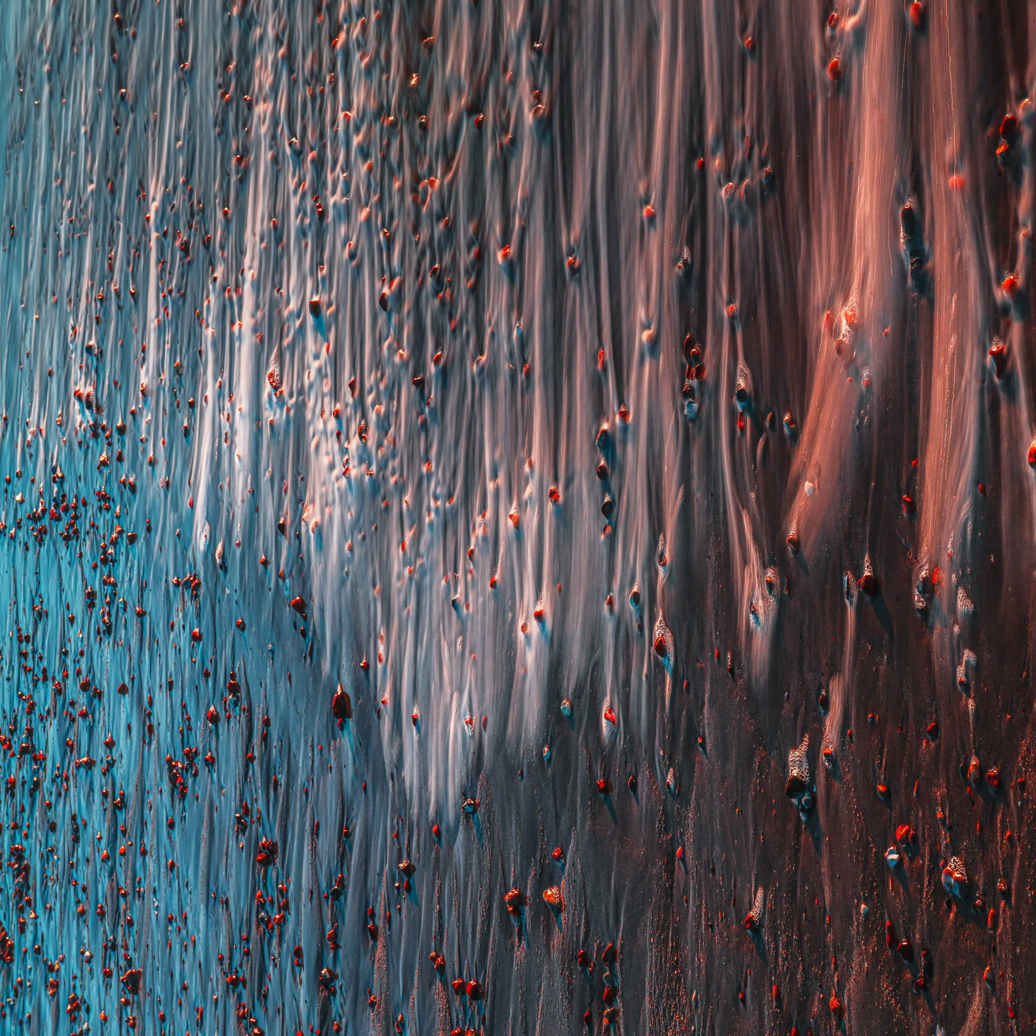 Abstract patterns shaped by tide and sunrise — a flowing, textural moment from the Sidmouth shoreline.