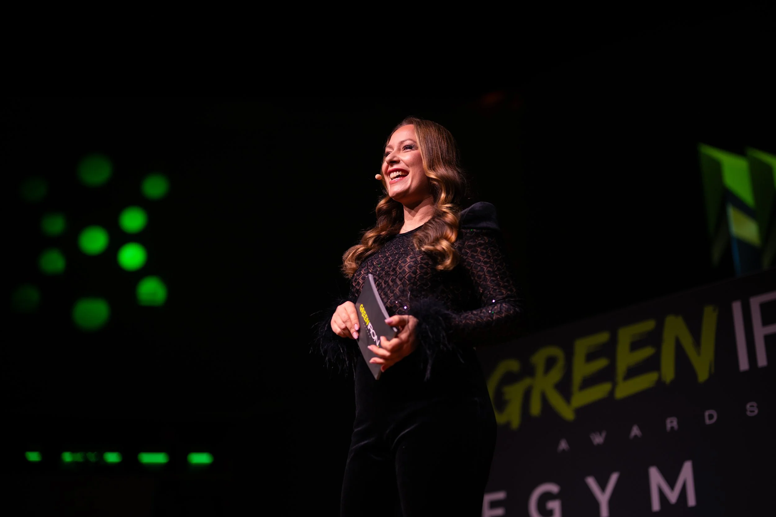 Eine lachende Frau hält einen Preis bei den Green Film Awards in Ägypten.