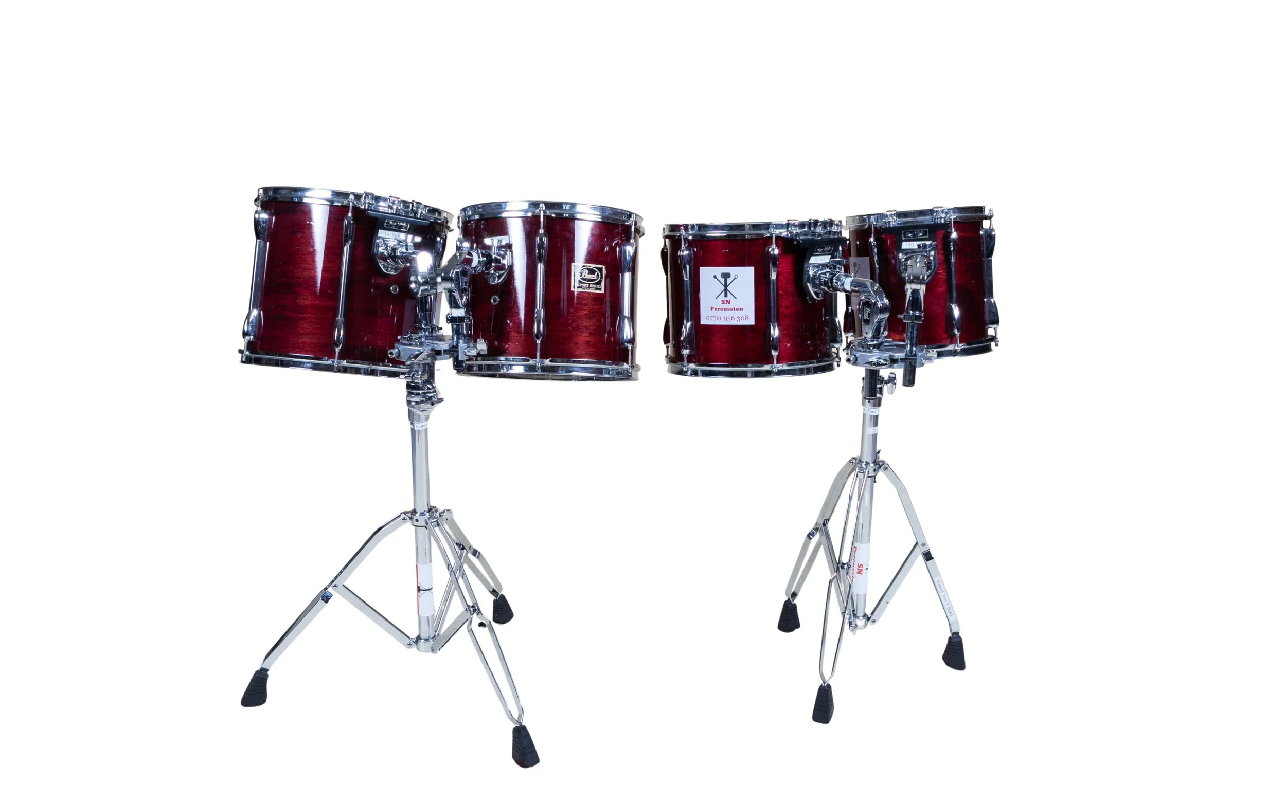Set of red drums on stands against a white background.