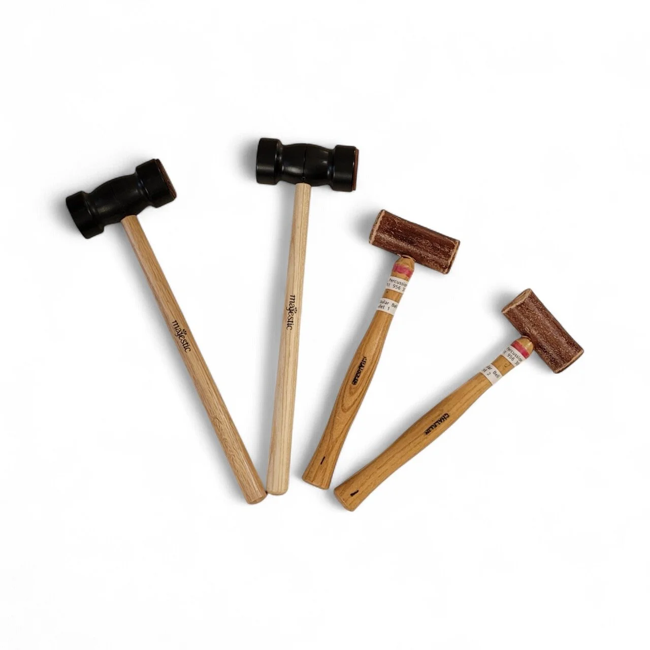 Four wooden mallets with black and brown rubber heads on a white background.