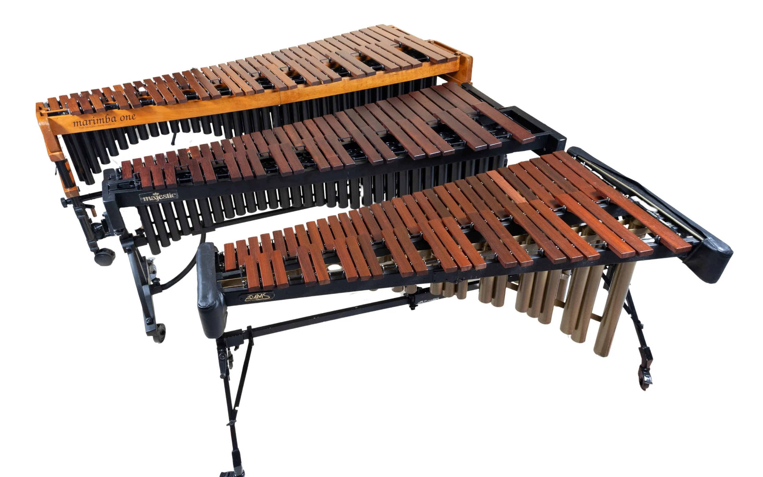 Three wooden and metal xylophones arranged in a row, with different brands and sizes, including Marimba One and Majestic, on a white background.