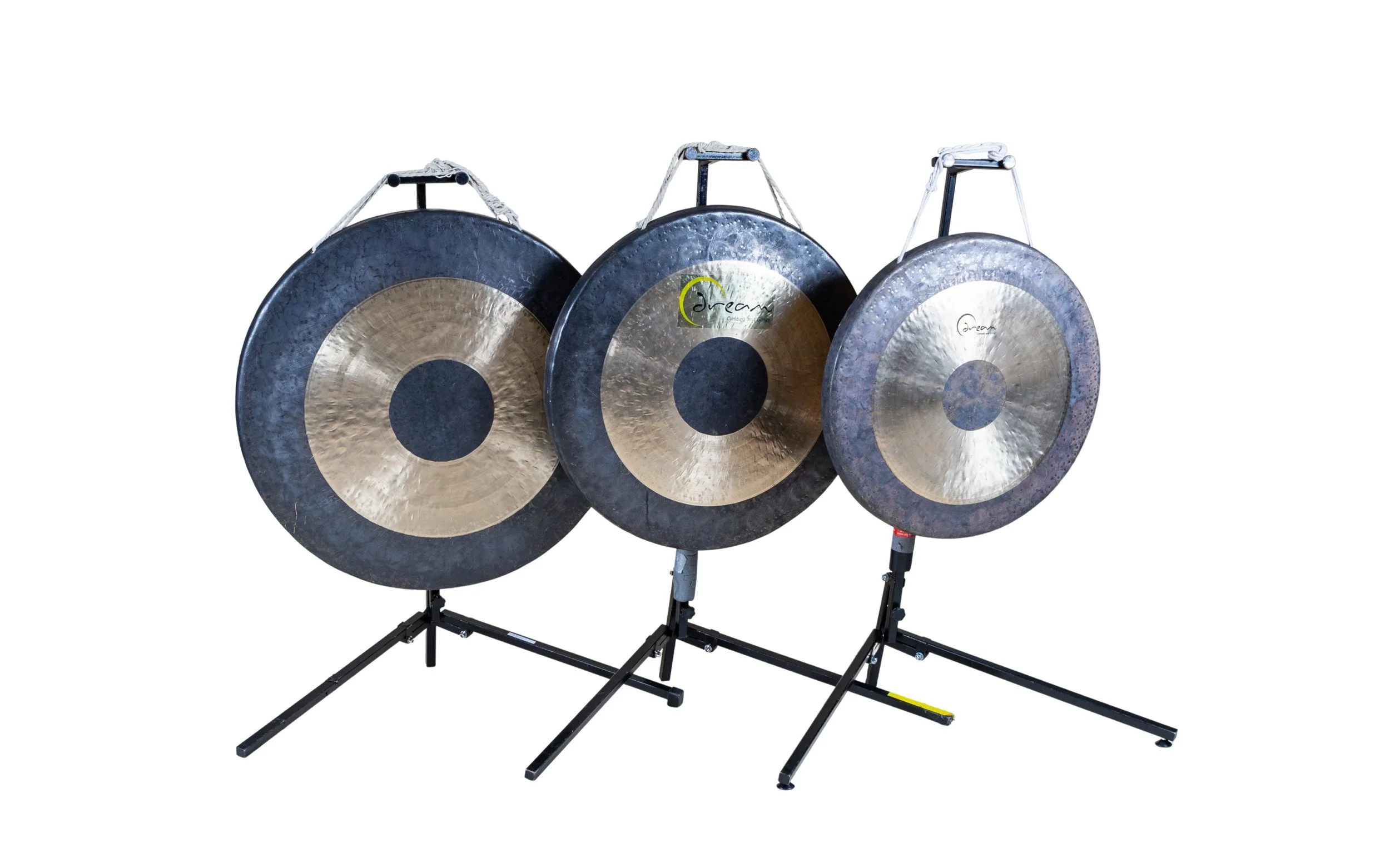 Three large gongs on black metal stands
