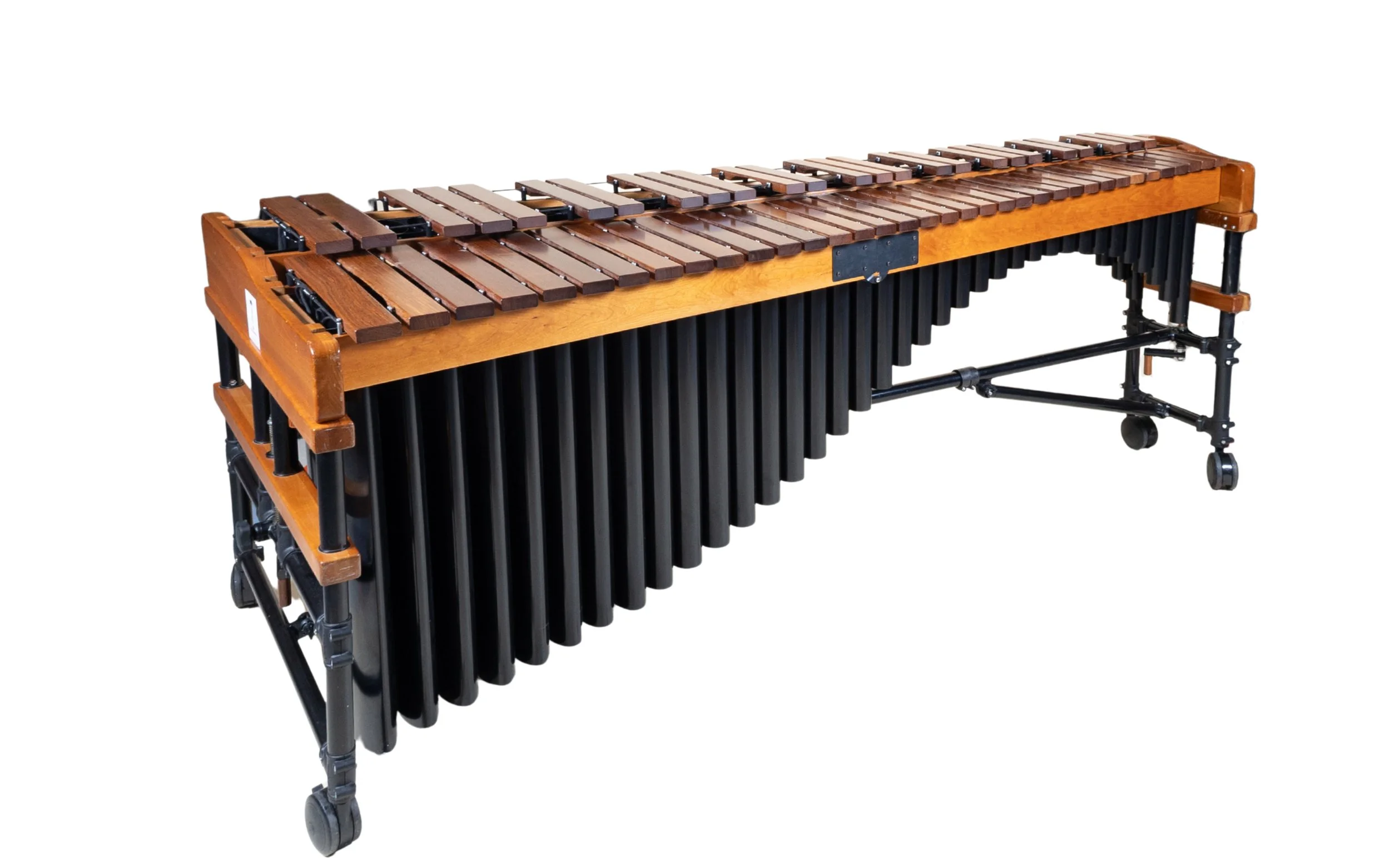 A wooden xylophone with black metal tubes hanging underneath, on a wheeled stand