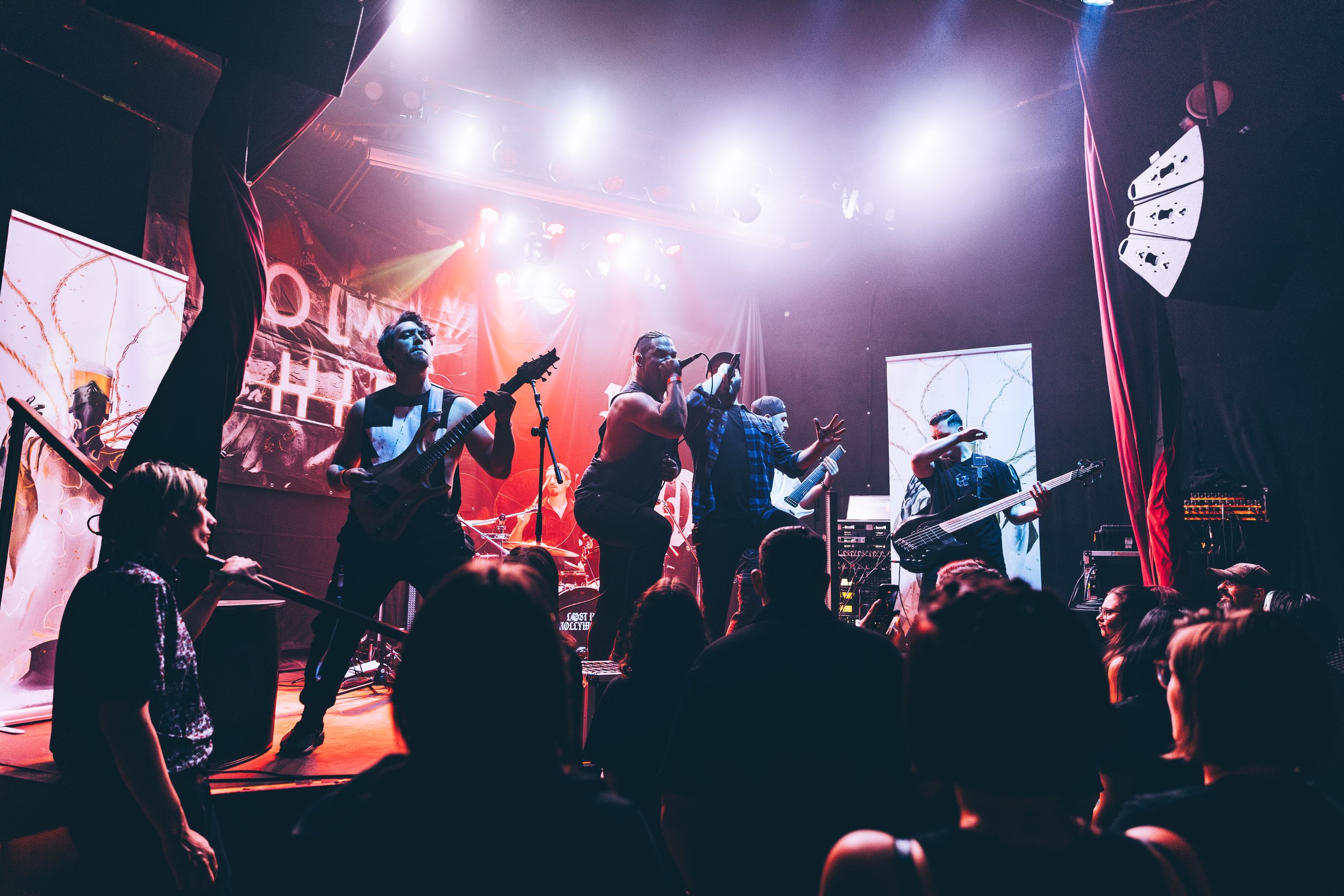 Polar Shift performing live on stage with audience under colorful concert lights.