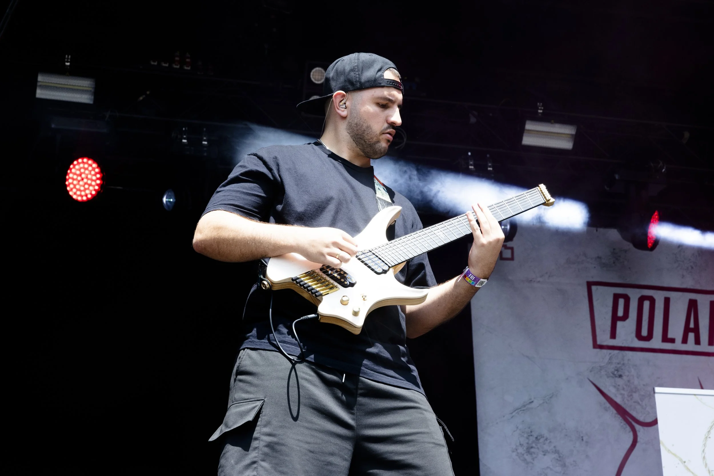 Polar Shift guitarist performing live on stage under stage lights.