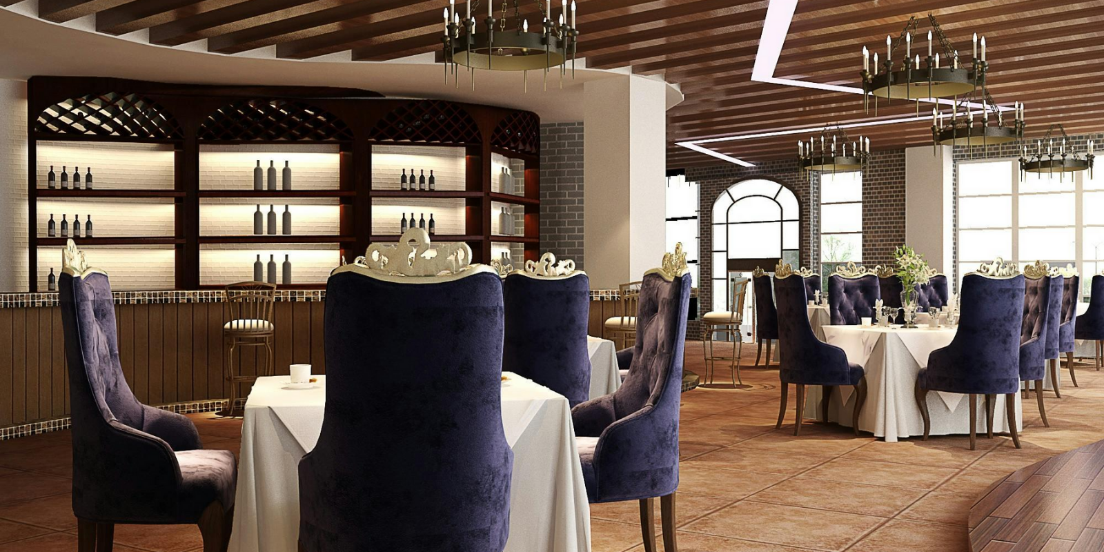 Elegant restaurant dining area with round tables covered in white tablecloths, purple velvet chairs, chandeliers, large windows, and shelving with bottles behind the bar.