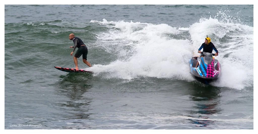 Big wave tow in surfers practicing during cyclone Irina