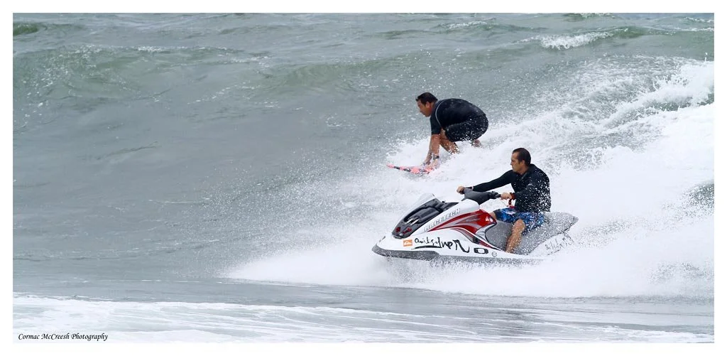 Big wave tow in surfers practicing during cyclone Irina