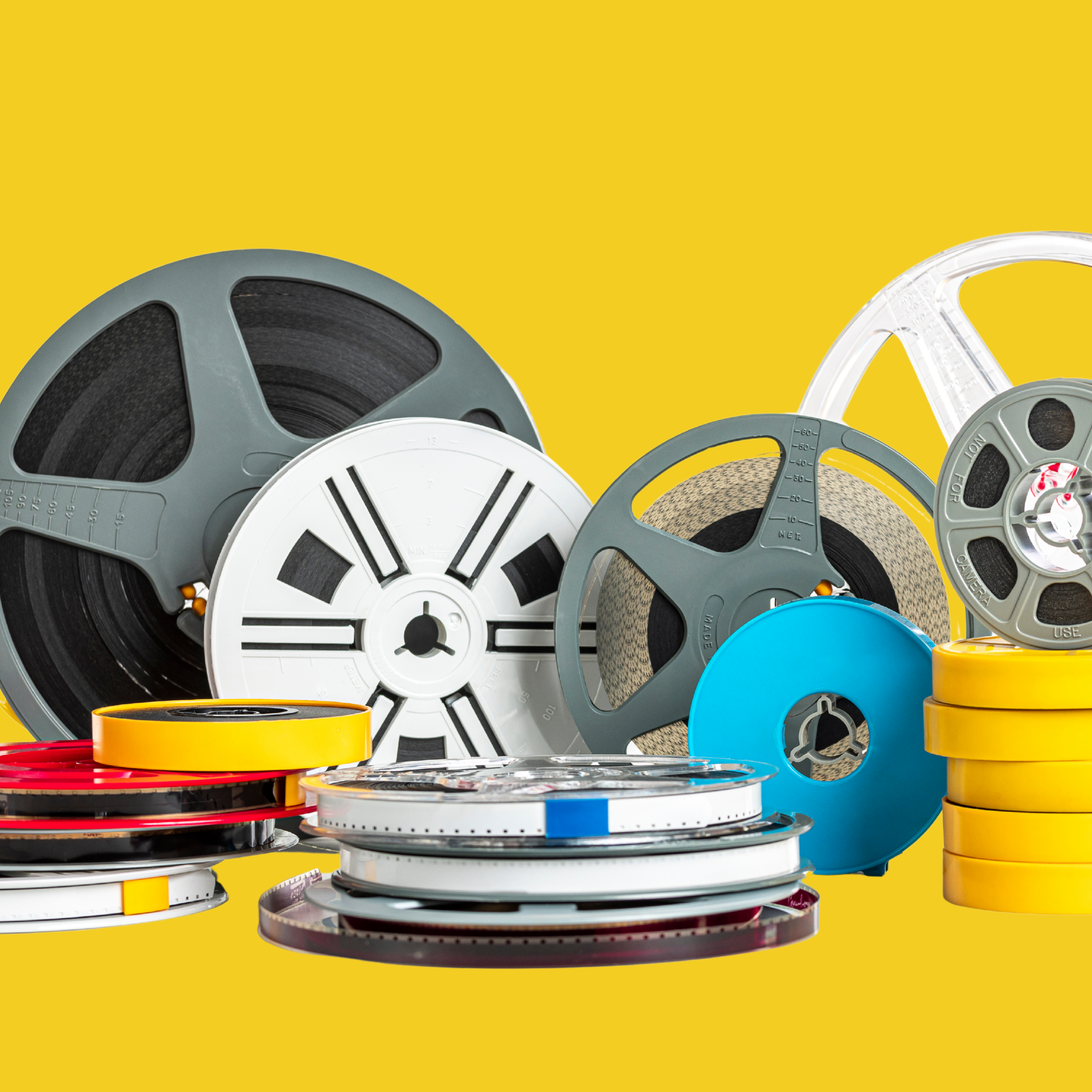 Collection of film reels and tape on a yellow background