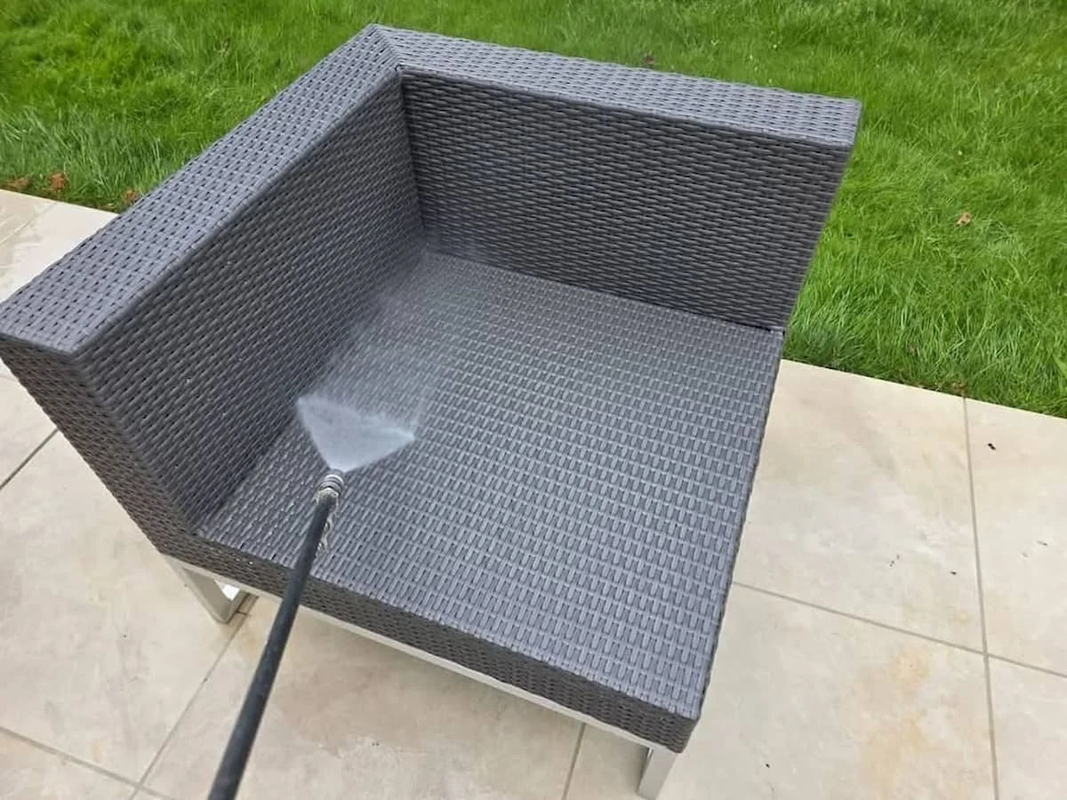 Professional jet washing and deep cleaning of a rattan garden sofa on a modern patio in Sonning.