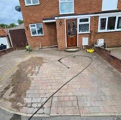 Before image showing pressure washing mosmatic equipment ready to clean dusty worn patio in Reading