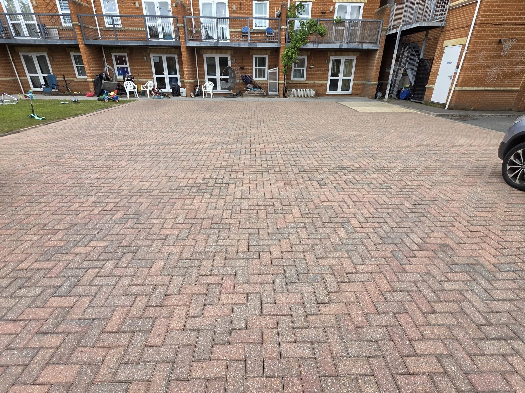 Large commercial driveway and patio transformation completed using pressure washing by Immaculate Services