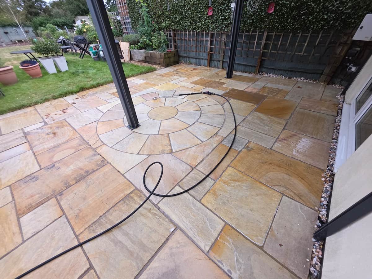 Clean Indian sandstone patio paving slabs after professional jet washing and stone restoration in Reading.