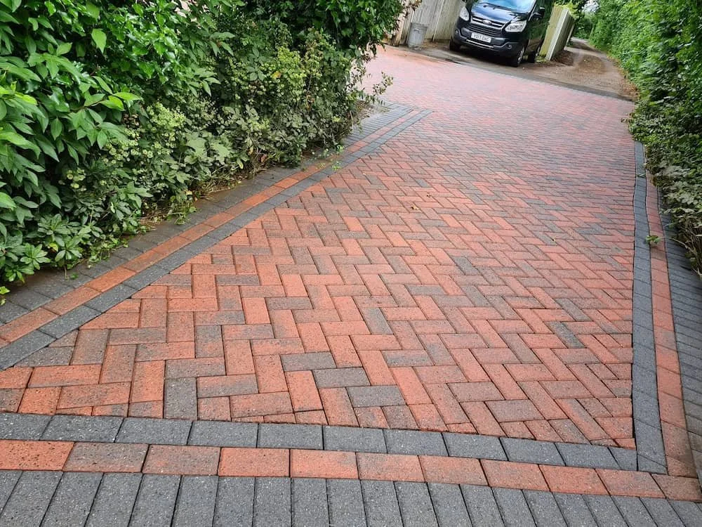 Restored red block paved driveway after professional jet washing deep cleaning and kiln-dried re-sanding in Caversham.