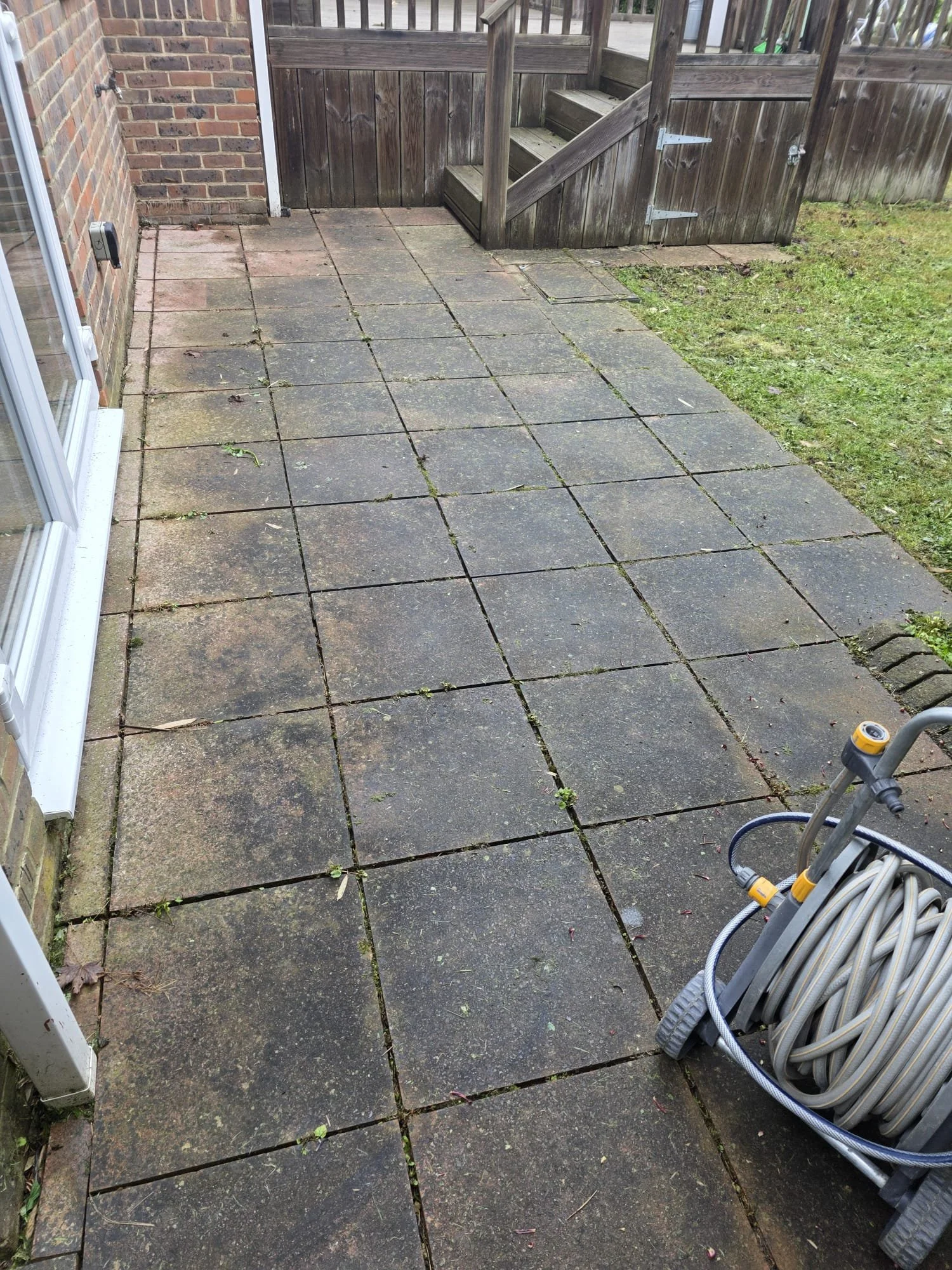 Patio before professional pressure washing in Reading.
