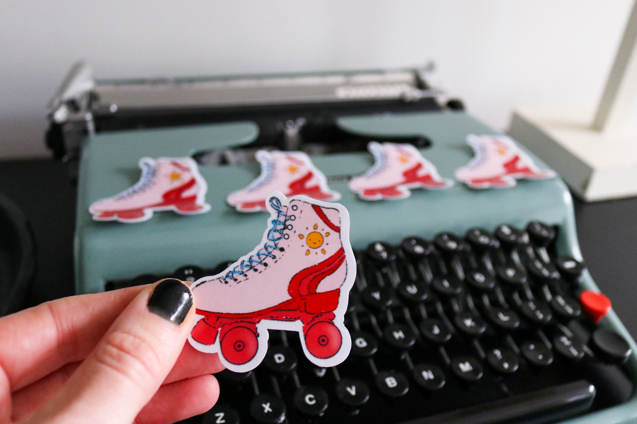 Retro pink roller-skate sticker with sun design
