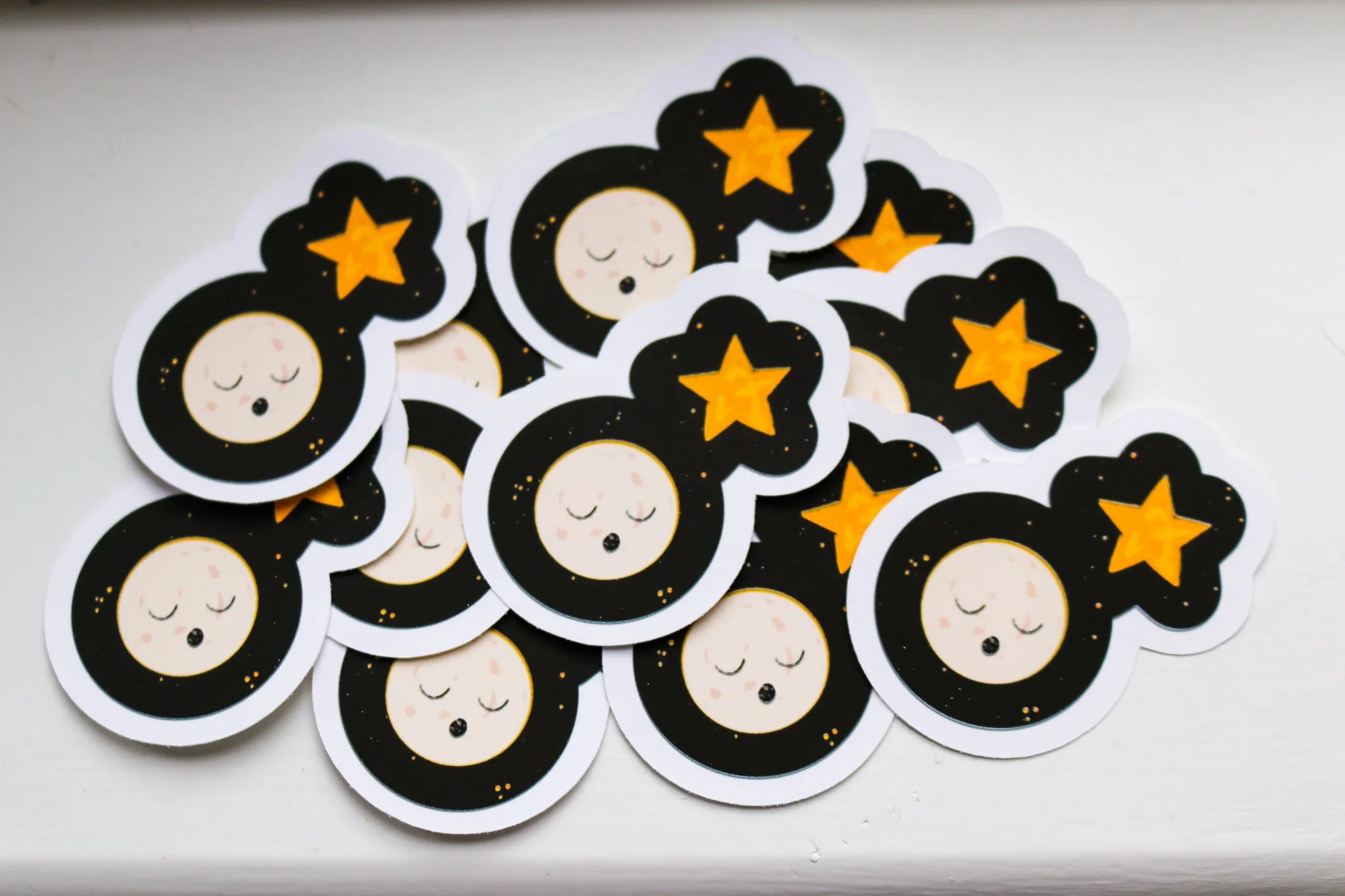 Sleepy moon stickers on a night sky background
