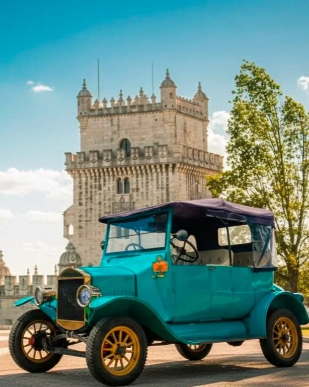Carro antigo de cor azul com capota preta em frente ao Torre de Belém em Lisboa, Portugal.