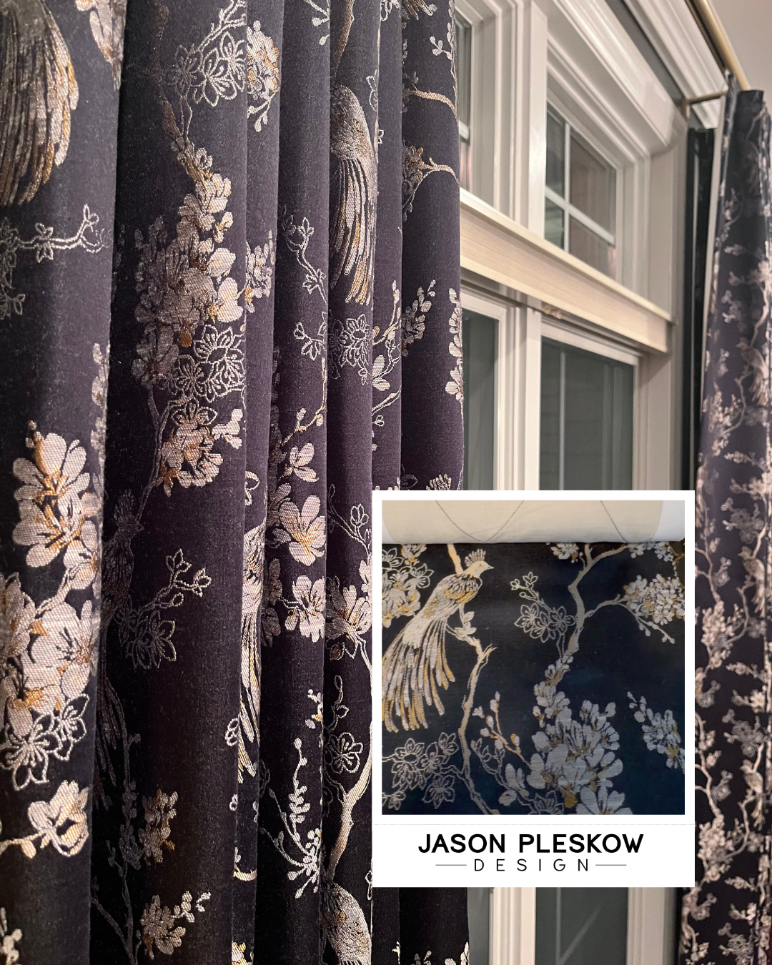 Close-up of dark fabric curtains with intricate gold and white floral and bird patterns hanging by a window.