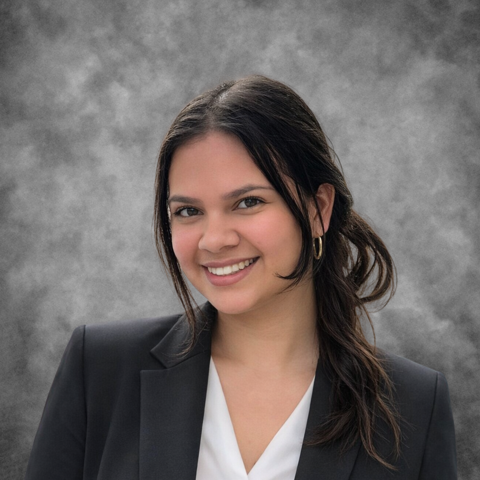 Night sky filled with stars above a silhouette of a mountain and a calm body of water.