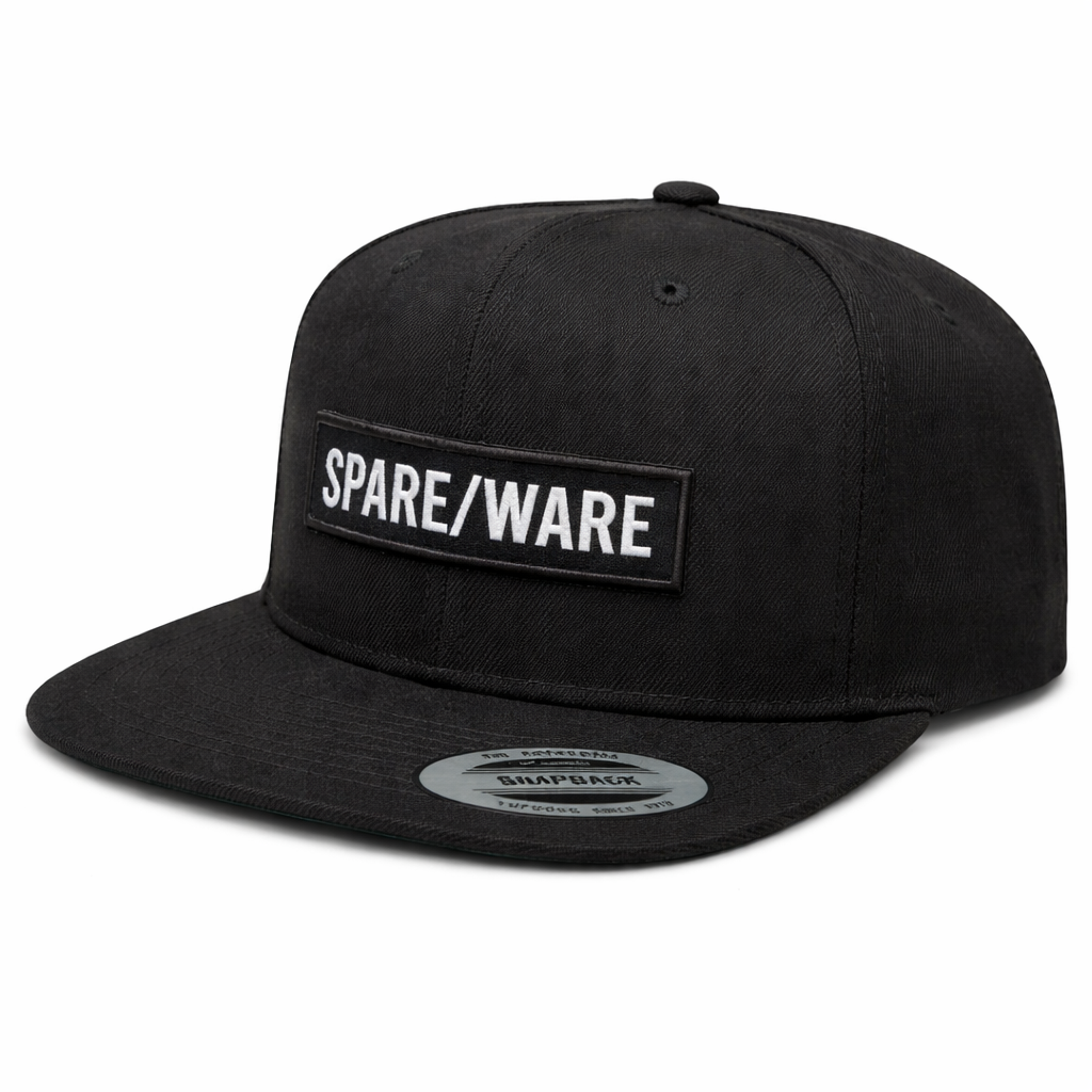 A black snapback hat with a rectangular patch that reads 'SPARE/WARE' in white letters.