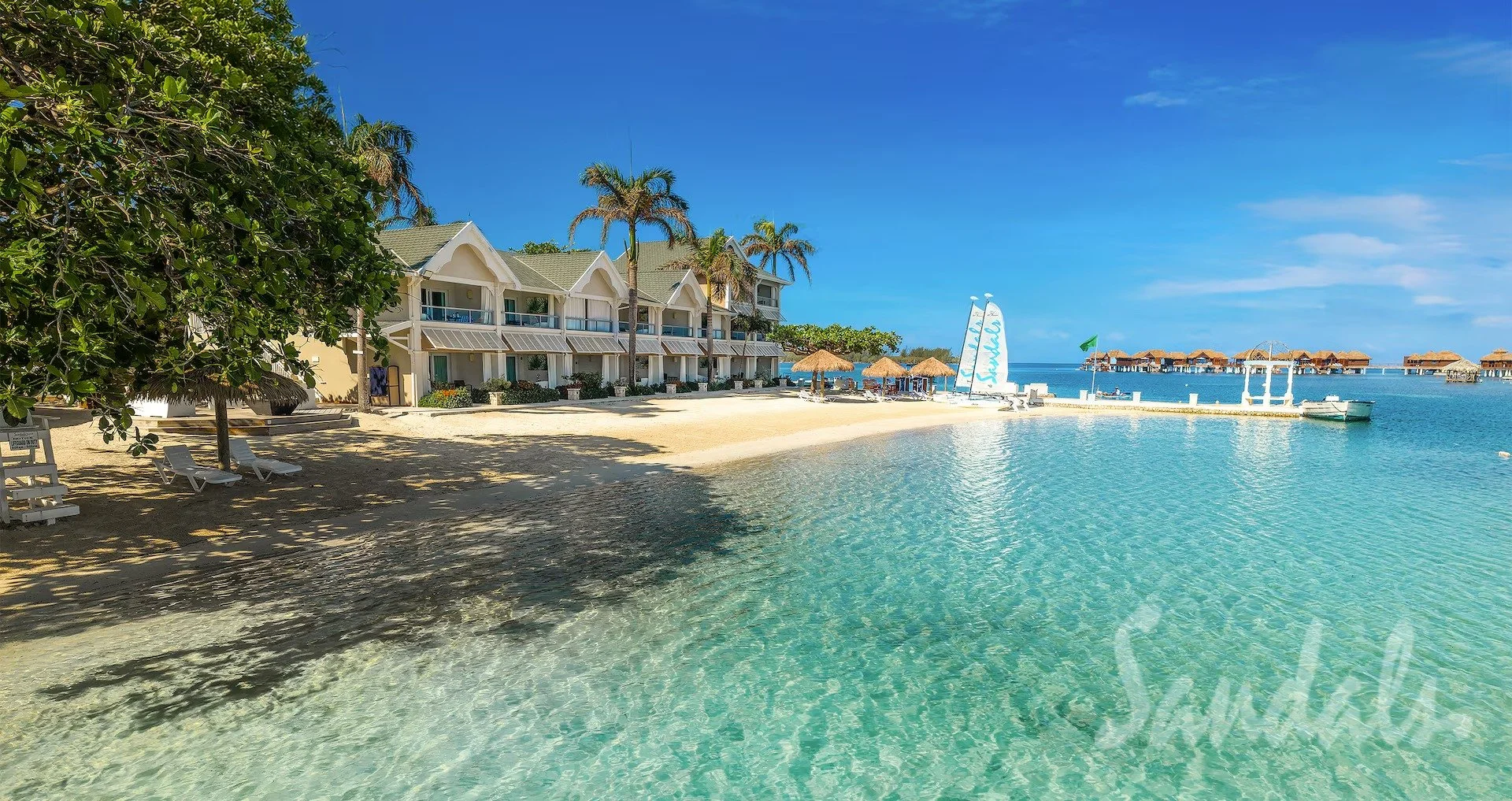 Sandals Royal Caribbean resort private offshore island with palm trees and hammocks over clear water, Montego Bay, Jamaica
